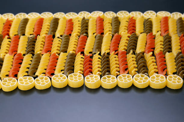 istock raw dry colorful pasta closeup 696073824