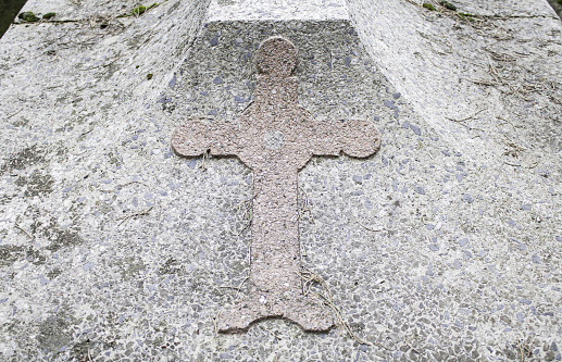 An iron cross and the Thinking Christ welcome the hikers on the Trekking of the Thinking Christ, an easy footpath in the Natural Park Paneveggio-Pale di San Martino. The work is by the sculptor Paolo Lauton, dated 2009.