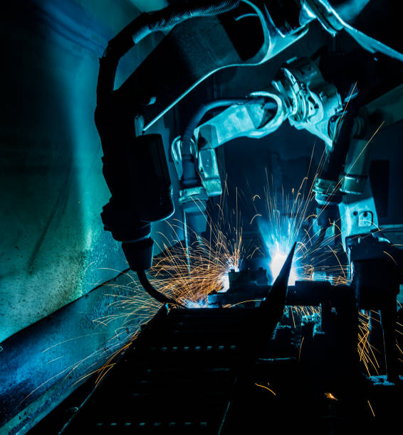 istock Motion Welding robots in a car factory with sparks 696080712