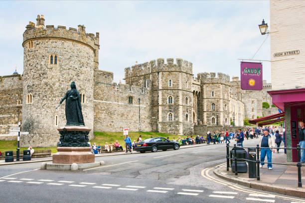 Panoramic of Windsor Castle with Christmas tree with no cars only tourists on a sunny and cloudy day.