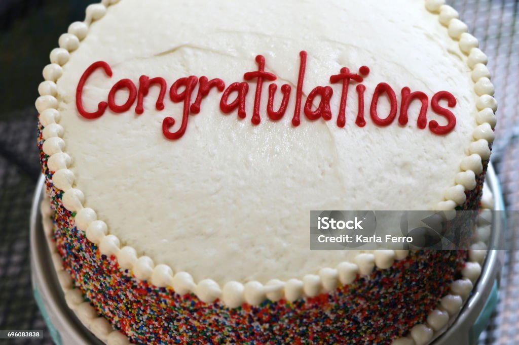 Congratulations Cake Cake with vanilla frosting.  Congratulations piped on it.  Multi-colored sprinkles all around Congratulating Stock Photo