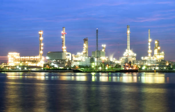 istock river side oil refinery industry plant along twilight morning 696090434