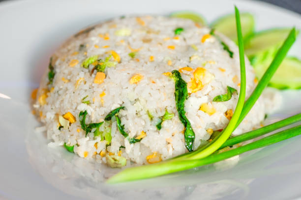 istock Rice with vegetables in a Thai restaurant close-up on a white plate 696091552