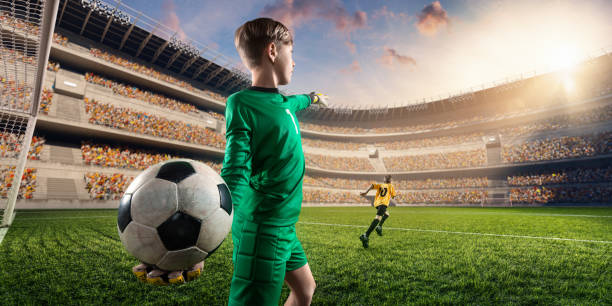 istock Soccer kids goalkeeper throws the ball 696091684