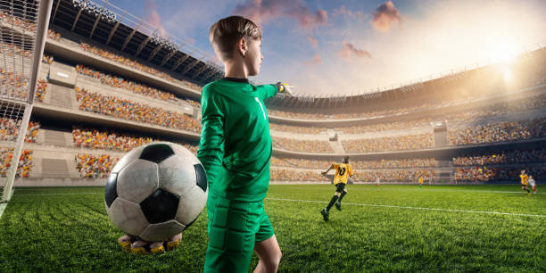 istock Soccer kids goalkeeper throws the ball 696091724