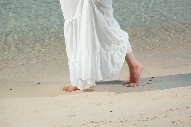 istock woman walking on a sandy beach .freedom . barefoot 696100138