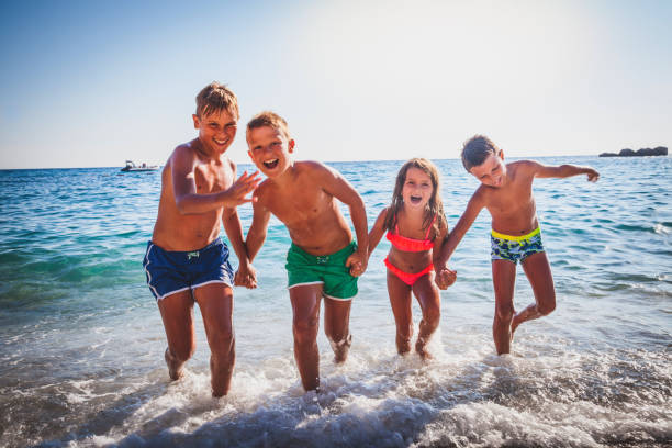 istock Happy Children on a Summer Vacation at the Beach 696100198