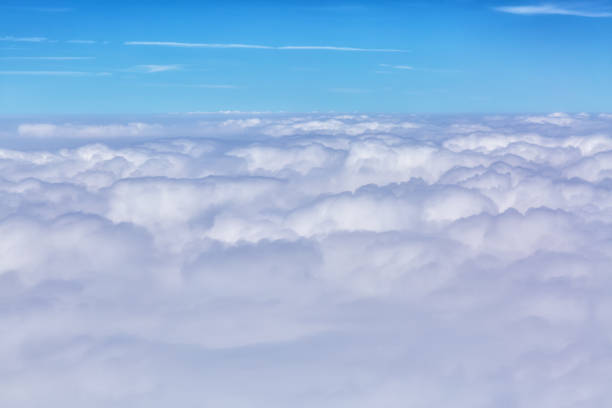 istock Clouds background with blue sky from above. View from airplane window 696103378
