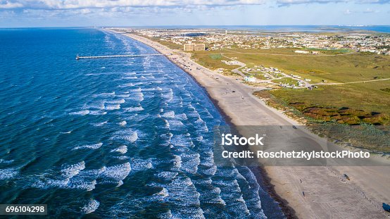 istock Sunrise on Padre Island from High Drone View with waves crashing along Beach 696104298