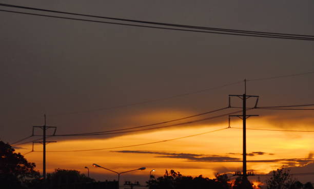 istock electric pole and cable line on twilight sky 696104608