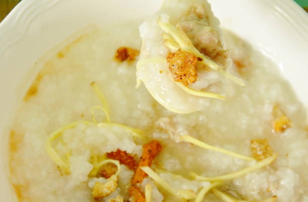 istock rice porridge with minced pork and slice ginger on spoon 696108138
