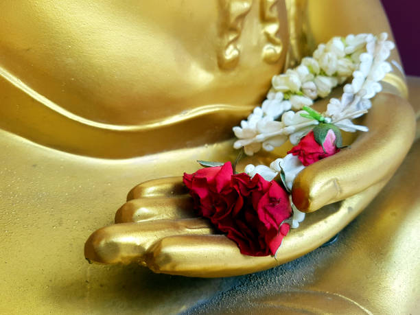 istock flower on buddha gold hands 696114514