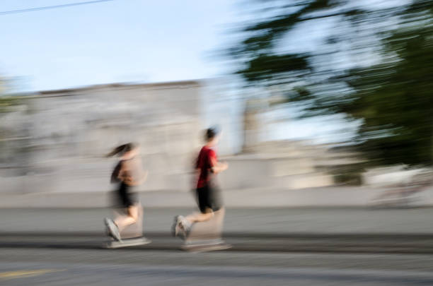 istock Panning of people jogging during summer day 696116832
