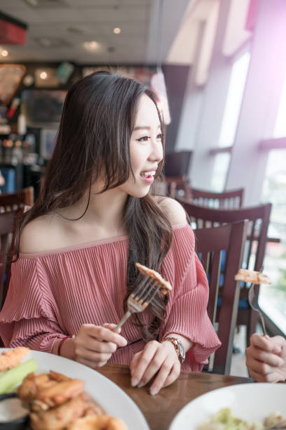 istock women dine in restaurant 696117316