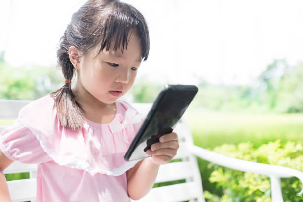 istock cute girl use phone 696118006