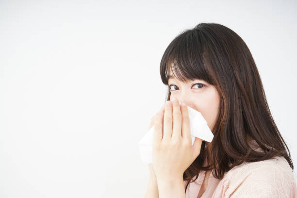 istock Young woman blowing her nose 696120730