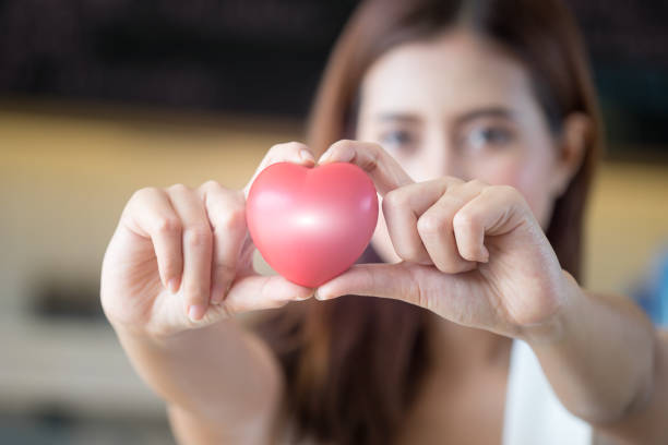 istock woman holding red heart in hands. 696124584
