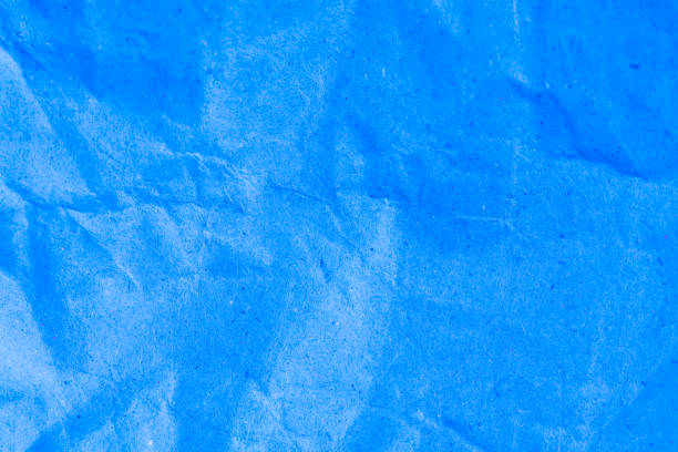 istock Blue vignette crumpled paper. 696130172