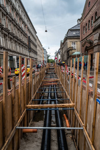 Trench shoring for pipe passage in historical city street Trench shoring for pipe passage in historical city street trench stock pictures, royalty-free photos & images