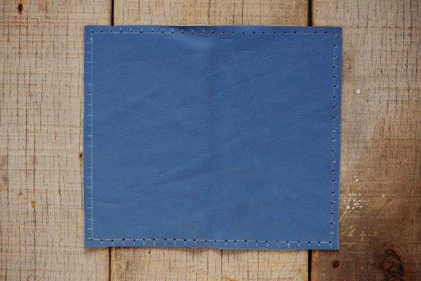 istock Blue leather on wooden. 696138334