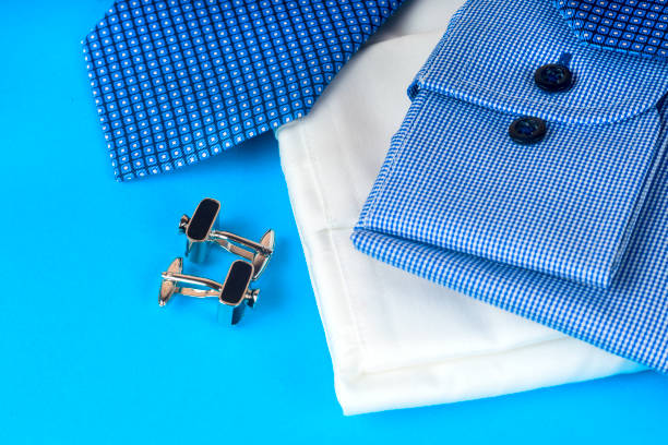 istock Stack of blue and white shirt closeup on a light background. 696144332