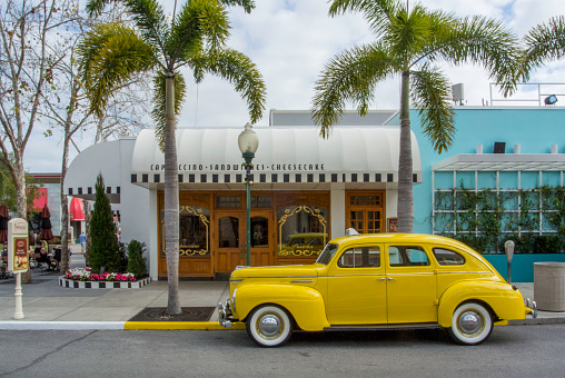 Orlando, Florida, USA - March 9, 2016: Vintage car parked on the roadside waiting for the guests, Classic cars are allowed to park at yellow line.