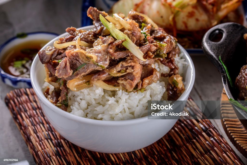 おいしい焼肉、漬け醤油とニンニク、生姜、ご飯の上 - 丼物のロイヤリティフリーストックフォト