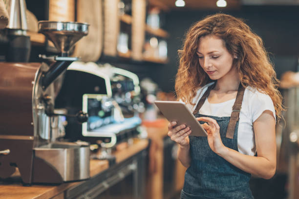 istock Beautiful barista with digital tablet 696156394