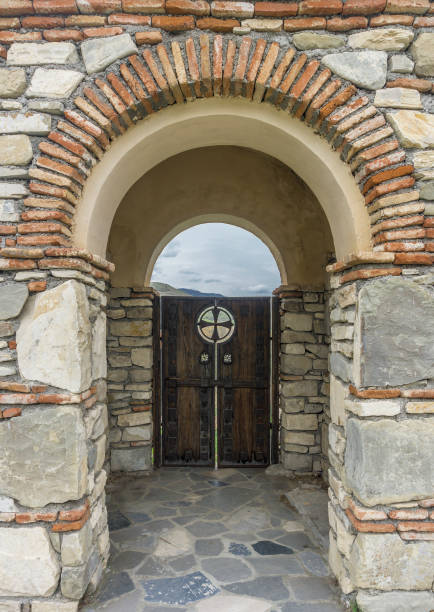 istock Brickwork, arch and wood door. 696159388