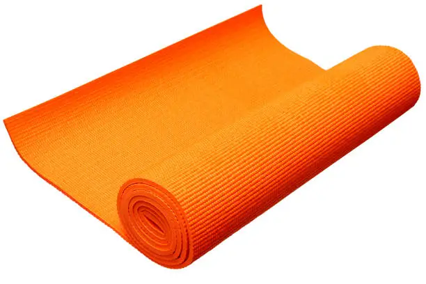 Orange yoga mat isolated on white background with clipping path.