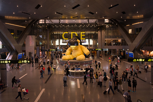 Passengers waiting for night flights walk through Hamad International Airport in Doha, Qatar (February 2017).