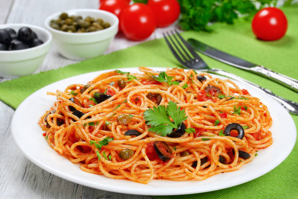 istock Pasta with tomato, capers, anchovy and olives 696166428