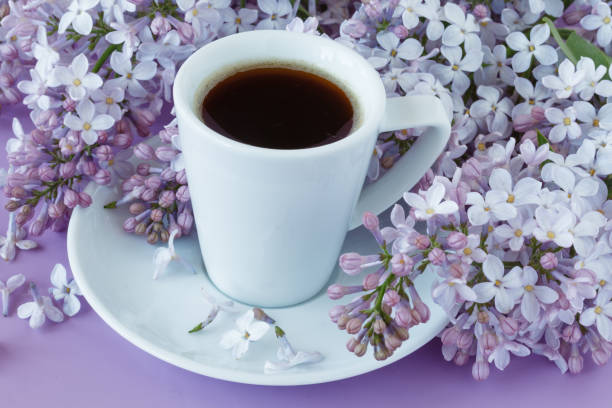 istock Romantic background with cup of tea, lilac flowers 696169296