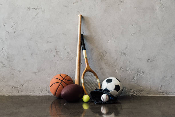 Close-up view of various balls and sports equipment near grey wall Close-up view of various balls and sports equipment near grey wall animal representation photos stock pictures, royalty-free photos & images