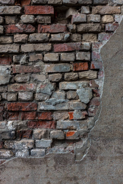istock The old brick and stone wall with plaster 696170614