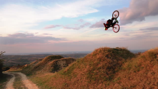 Skillful man on mountain bicycle practicing on extreme terrain.