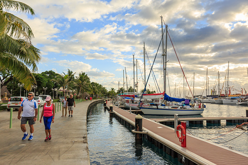 Papeete, French Polynesia - June 10, 2016 : The sailing boat park in sunset time at Large seaport in Tahiti Papeete, French Polynesia.