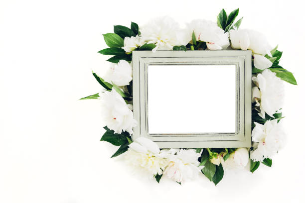 istock Pastel wooden frame decorated with peonies flowers, space for text. mock up 696173808
