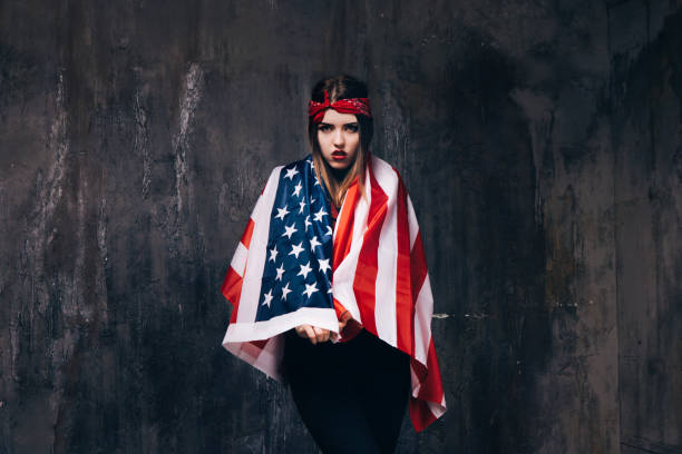 istock Girl dressed in USA flag on dark background 696174476