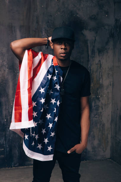 istock Confused afro american man with american flag 696175034