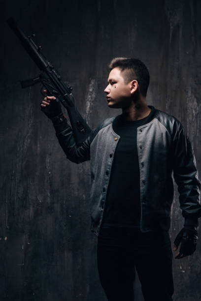 istock Tattooed killer with sniper rifle in black 696176406