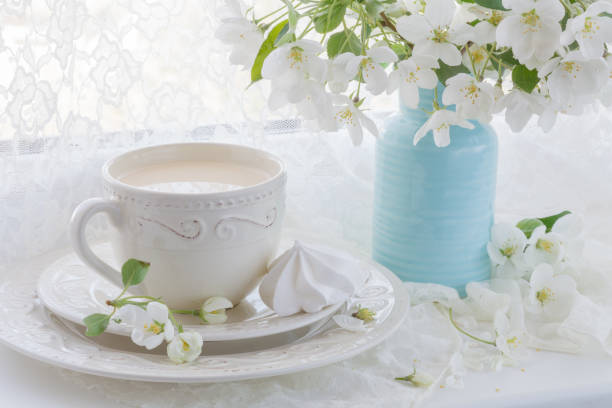 istock Still life with tea cup and blossom branch 696179128