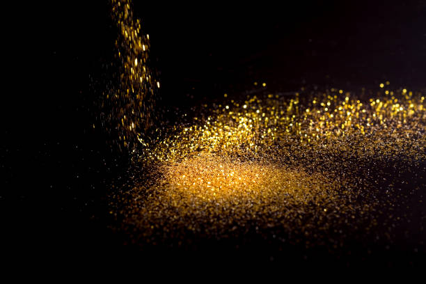 istock Sprinkle gold dust on a black background with copy space 696181496