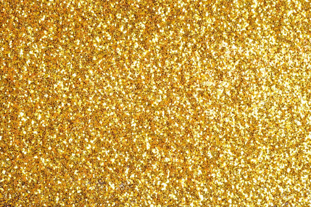 istock Sprinkle glitter gold dust on a black background with copy space 696181554