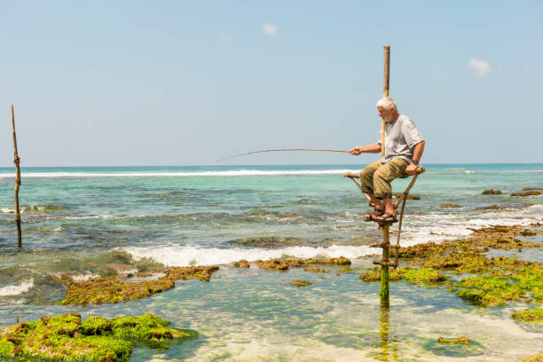 istock Tourist stilt fishing 696182604