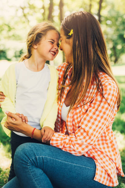 istock Mother and daughter rubbing noses 696183474