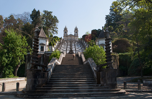 Braga, Portugal - March, 28, 2012: a pilgrim climbing the steps of the church of Bom Jesus do Monte, the sanctuary of Jesus of the Mount built in 1722 in Tenoes, outside the city of Braga