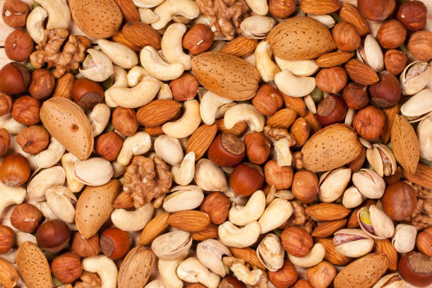 istock Mix of different nuts as background close-up 696183636