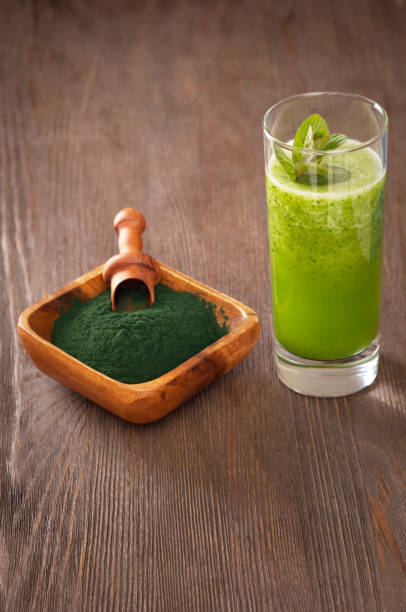 istock Green smoothie with spirulina on wood background 696186514