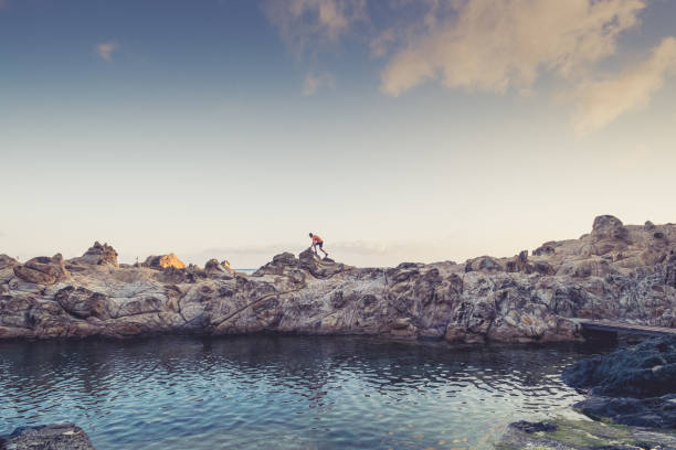 istock Man hiking on a mountain over the sea 696189602